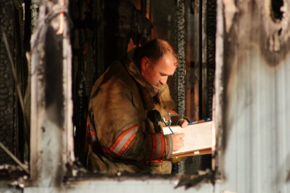 A fire investigator inside the burnt out trailer. (Tom Sofield/LevittownNow.com)