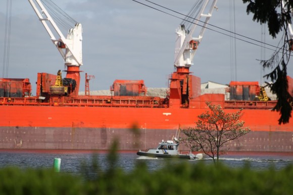 A New Jersey State Police boat passes the massive ship Monday afternoon. Credit: Tom Sofield/LevittownNow.com