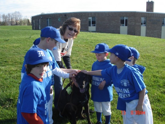 Brookline Lab Rescue Volunteer Peg Odham with her dog Rookie at the opening day for the Middletown Athletic Association's baseball season. Credit: Peg Odham/Submitted