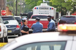 Officers at a police staging around around the corner from the standoff location on Saturday afternoon. Credit: Tom Sofield/LevittownNow.com