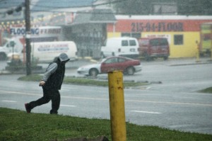 A man runs across East Lincoln Highway in Penndel Friday afternoon in the rain. Credit: Tom Sofield/LevittownNow.com