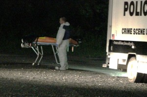 An official waiting with the body late Friday night. Credit: Tom Sofield/LevittownNow.com