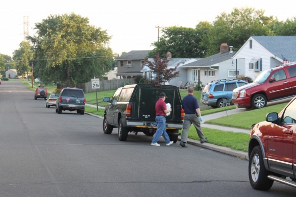 Officials carry the body of the infant to a waiting coroner's truck.  Credit: Tom Sofield/LevittownNow.com
