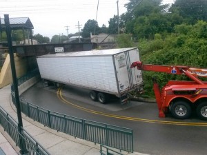 Truck gets hooked up for removal from Cedar St.  