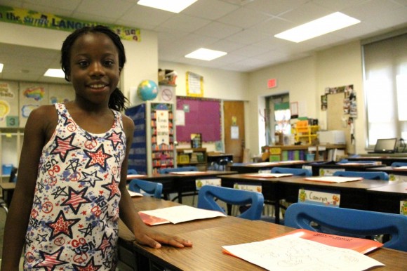 Ralphene Barpoh stands next to her desk in her new class. Ralphene said he was "happy" she wasn't in the same as her twin sister. Credit: Tom Sofield/LevittownNow.com
