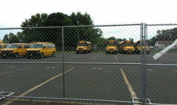 Temporary security fencing has been placed around a section of the parking lot of the Ben Franklin School in Bristol Township. About 80 buses and vans from the school district and new district transportation contractor Student Transportation of America (STA) will be housed at the facility. Superintendent Dr. Samuel Lee said Friday the district is still looking for a permanent home for the buses. Credit: Tom Sofield/LevittownNow.com