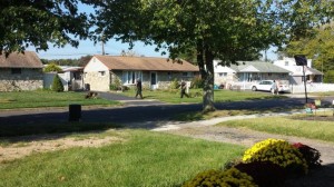 An image shows two police officers and K-9 unit searching for the wanted person.  Credit: Michael Colucci/Submitted