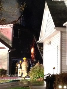 Flames can be seen from the side of the house. Credit: Janet Sauerbry/Submitted