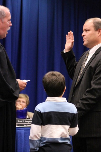 Congdon's son hold a bible as his father is sworn in, Credit: Tom Sofield/LevittownNow.com
