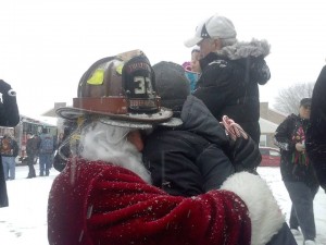 Santa hugging David outside his grandparents home on Sunday in Bensalem Credit: Jeff Bohen/LevittownNow.com