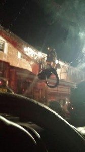 Credit: Anita Bennett  First responder goes up in bucket during last nights fire. 