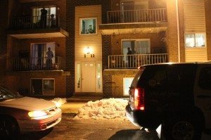 Neighbors look out at police near the scene of the stabbing. Credit: Tom Sofield/LevittownNow.com
