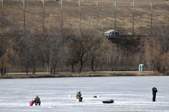 A group of people ice fished on the lakes at Penn Warner in Falls Township on Sunday afternoon. After three men fell through on Saturday, fire officials are warning people the ice is not safe after several days of above-freezing temperatures.  Credit: Tom Sofield/LevittownNow.com