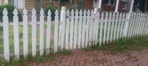 The white fence that borders the residence looks to be weakened and  in disrepair.  Image Credit: Jeff Bohen  LevittownNow.com 