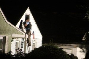 A detective looking in an attic. Credit: Tom Sofield/LevittownNow.com