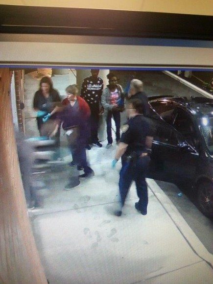 Police are looking to speak with the two people standing against the pillar in the back of the photo. Credit: Bristol Township Police