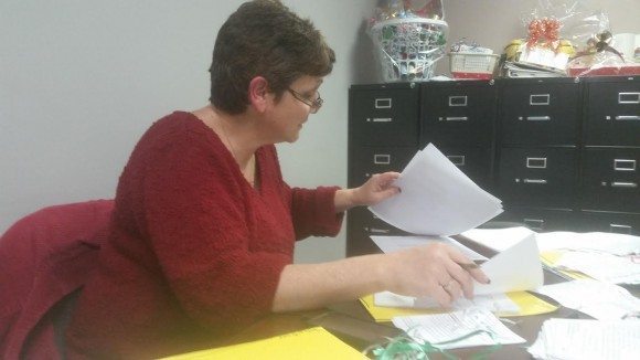Image Credit: Jeff Bohen LevittownNow.com President of the Christmas Gala, Inc Cheryl Campbell goes over lists for her Angel Tree matches in her new office on Radcliffe Street last week,