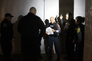 Falls Township police and sherrif's deputies go over warrants before a sweep in November 2014.  Credit: Tom Sofield/LevittownNow.com