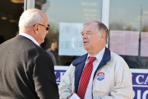 A man talks to Middletown resident Andy Warren outside the polling place at Maple Point Middle School. Credit: Tom Sofield/LevittownNow.com