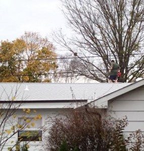 An image detectives captured that is alleged to show Douris clearing leafs from his roof. Credit: Bucks County District Attorney