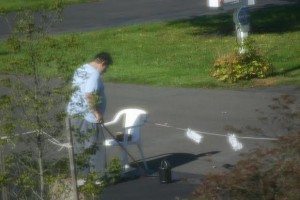 An image detectives captured that is alleged to show Douris sealing his driveway. Credit: Bucks County District Attorney