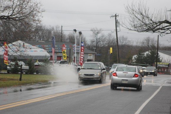 A minivan drives through a large puddle on Bath Road in Bristol Township Tuesday afternoon. Credit: Tom Sofield/LevittownNow.com