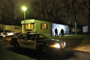 A police officer examines the house where the standoff took place. Credit: Tom Sofield/LevittownNow.com