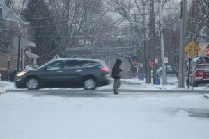 A man in a jacket walks along West Lincoln Highway in Penndel Borough Tuesday evening. Credit: Tom Sofield/LevittownNow.com