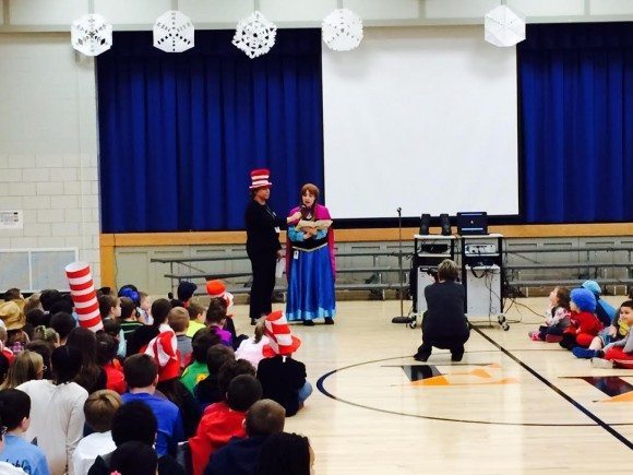 Eleanor Roosevelt Elementary principal Elizabeth Aldridge (center) reading a Dr Seuss book to students during an assembly on Friday. She is dressed as the character Anna from "Frozen." Credit: Pennsbury School District