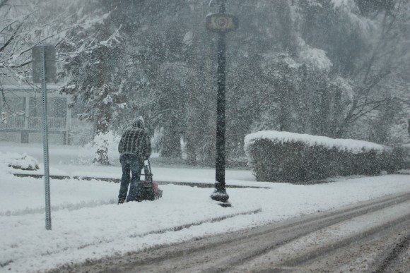 A man uses a snowblower to clear the sidewalk along Bellevue Avenue in Langhorne.  Credit: Tom Sofield/LevittownNow.com