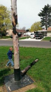 A child runs near the burnt remains of a cross.  Credit: Tom Sofield/LevittownNow.com