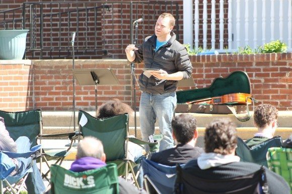 Pastor Ross Manders reading scripture from a tablet.  Credit: Tom Sofield/LevittownNow.com