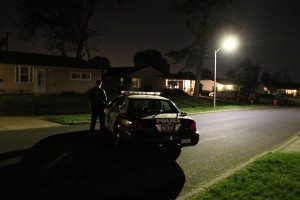 An officer stands guard on Buttonwood Lane as a SWAT team searches a home.  Credit: Tom Sofield/LevittownNow.com