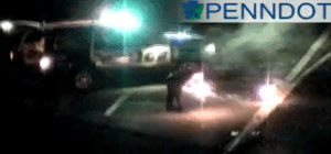 A police officer putting a flare on Route 1 Saturday night. Credit: PennDOT