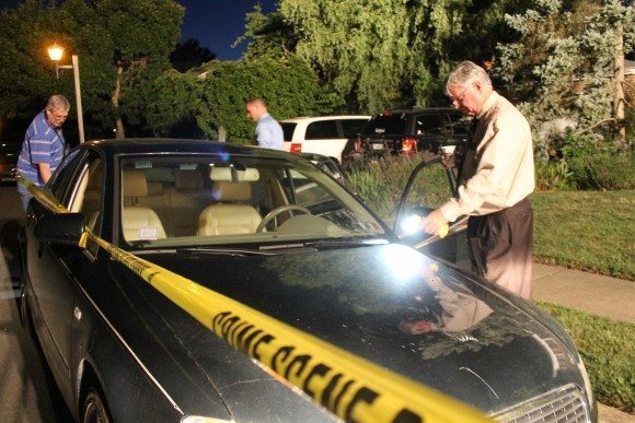Investigators look at a car believed to have belonged to the suspect.  Credit: Tom Sofield/LevittownNow.com