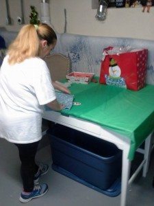 A volunteer wrapping a Christmas gift this November. Credit: The Christmas Gala