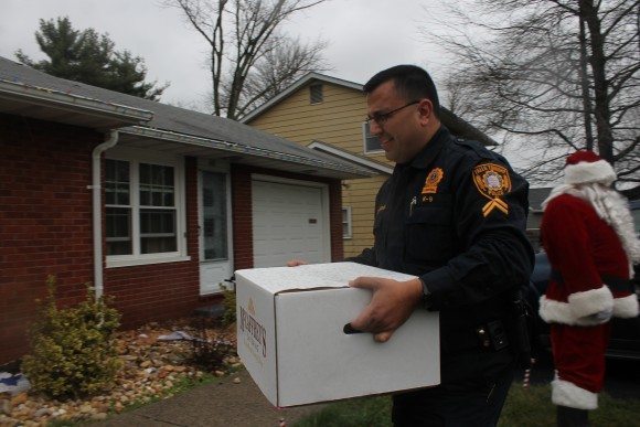 Corporal Steven Langan delivering Christmas dinner to the Wright family. Credit: Tom Sofield/LevittownNow.com