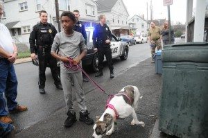 Zaikil Lawrence listens to instructions on how to take care of his new dog. Credit: Alex Lloyd Gross/ LevittownNow.com