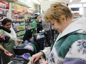 A woman purchases Powerball tickets at Levittown News & Tobacco in Fairless Hills. (File Photo) Credit: Tom Sofield/LevittownNow.com