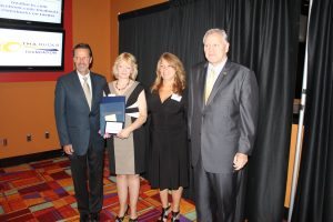 Rearick (second to the left) after receiving her award.  Credit: Tom Sofield/LevittownNow.com