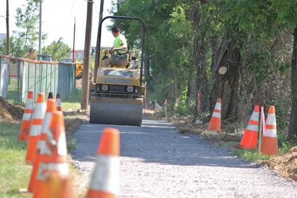 A contractor works on the sidewalk project on Wednesday.  Credit: Tom Sofield/LevittownNow.com