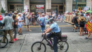 A police officer on a bike watches over protesters Sunday. Credit: Tom Sofield/LevittownNow.com