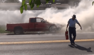 A postal worker after he used an extinguisher to hold down flames. Credit: Ron Roberts/YouTube