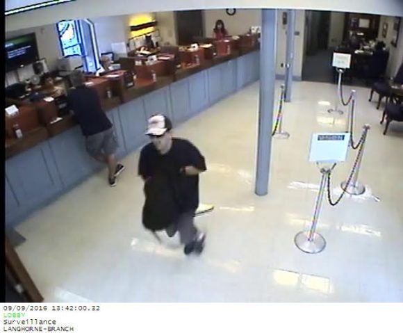 The suspect leaving the bank. Credit: Submitted