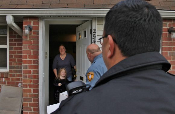 Stephanie Bodine and he daughter Anna greet the officers on Thanksgiving morning. Credit: Tom Sofield/LevittownNow.com