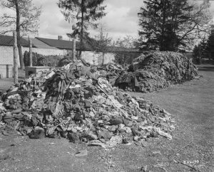 A photograph from 1945 shows tattered clothes from prisoners who were forced to strip before they were killed in piles outside the Dachau concentration camp. Credit: National Archives/Records of the Office of the Chief Signal Officer 