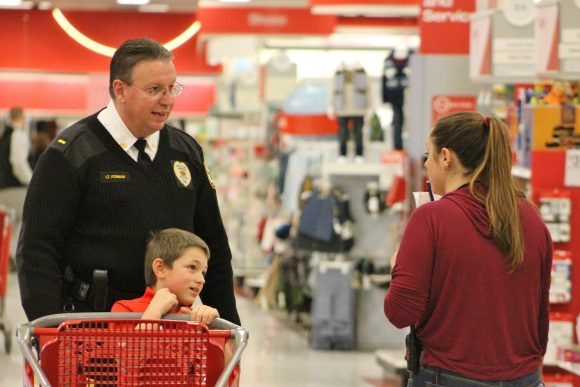 Lt. Steve Forman and Kayden Beishl, 6, talking to a Target employee. Credit: Tom Sofield/LevittownNow.com