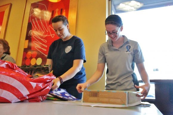 Volunteers from the Detective Christopher Jones Foundation help wrapping gifts. Credit: Tom Sofield/LevittownNow.com
