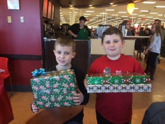 Nicholas and Brady Greene with their wrapped gifts. Credit: Melisa Batot/ Detective Christopher Jones Foundation