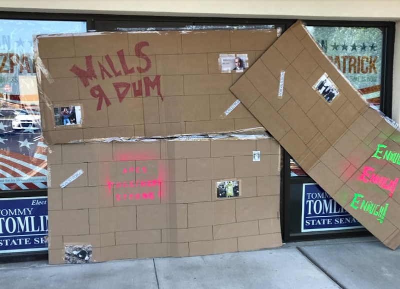 ‘Walls R Dum’ Boards Put Up At Congressman’s Campaign Office